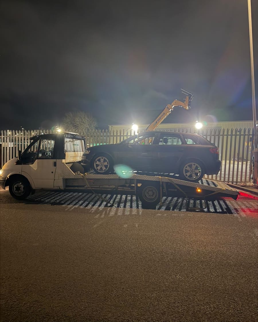 Swindon Transport & Recovery loading a car at night